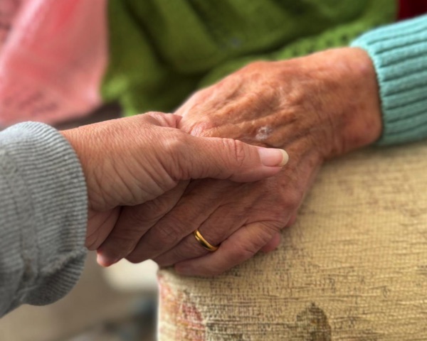 Carer holding hands with client